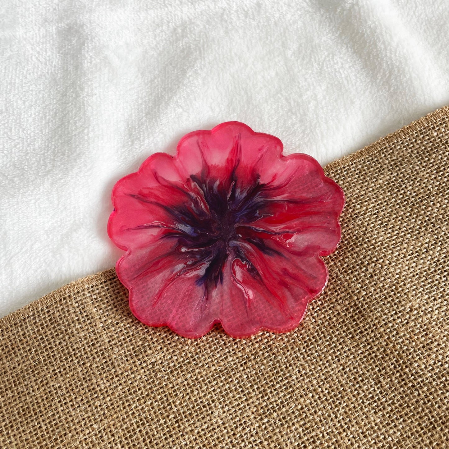 Artisan floral resin coaster with pink base and purple marbling, handmade home accent