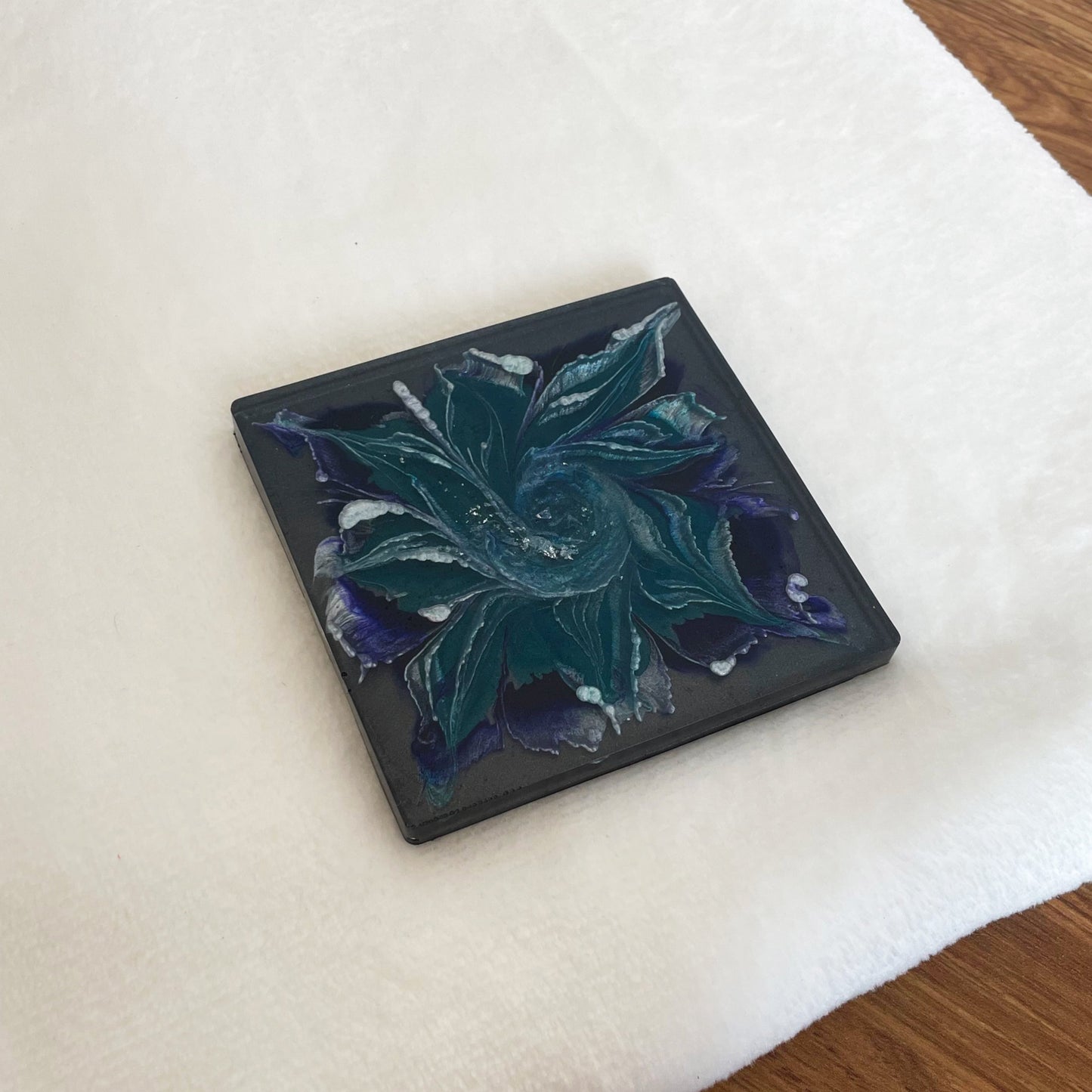 Handmade resin coaster with black and blue swirls, stylish coffee table décor and functional artisan décor