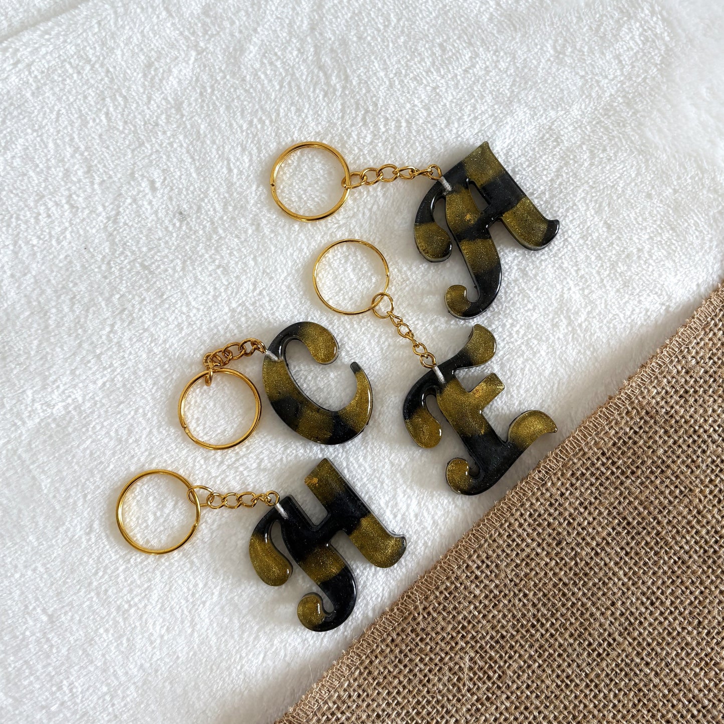 Handmade black resin keyring with gold marble swirl design