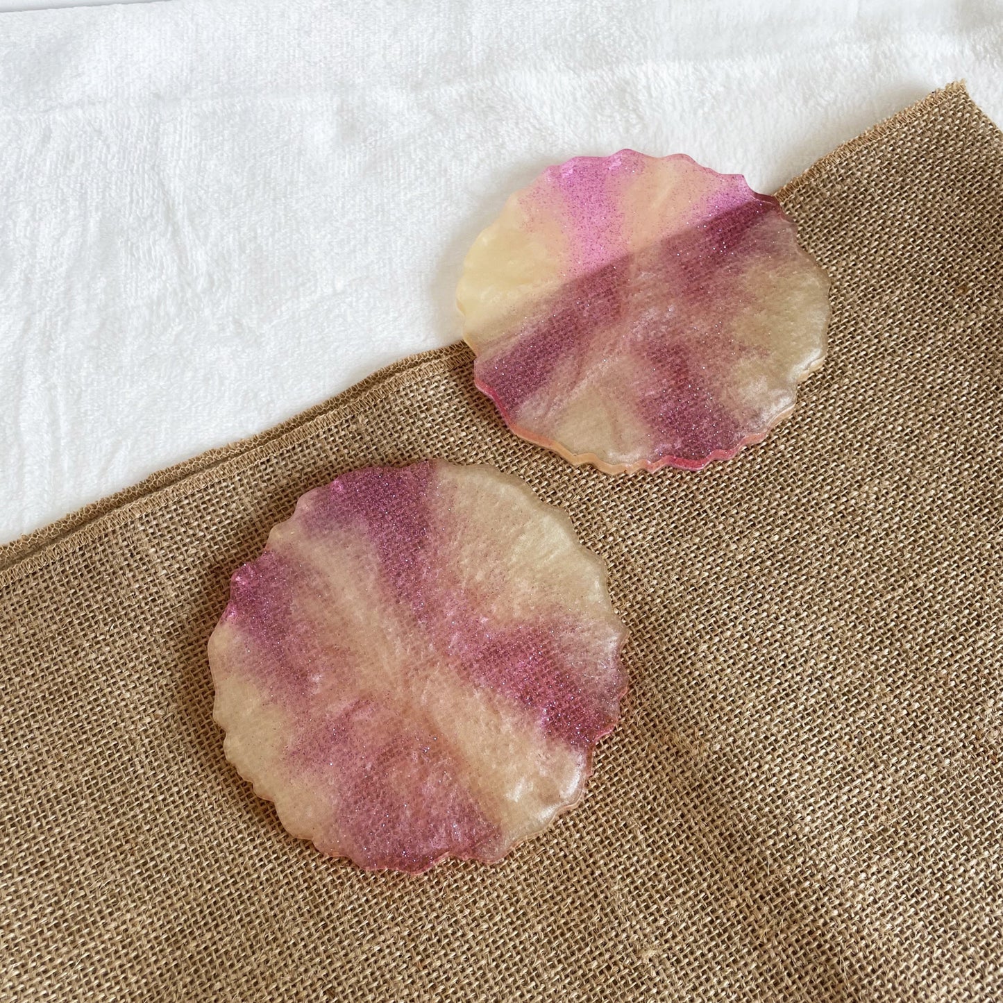 Pink and yellow marbled resin coaster with subtle glitter shimmer, handmade table décor