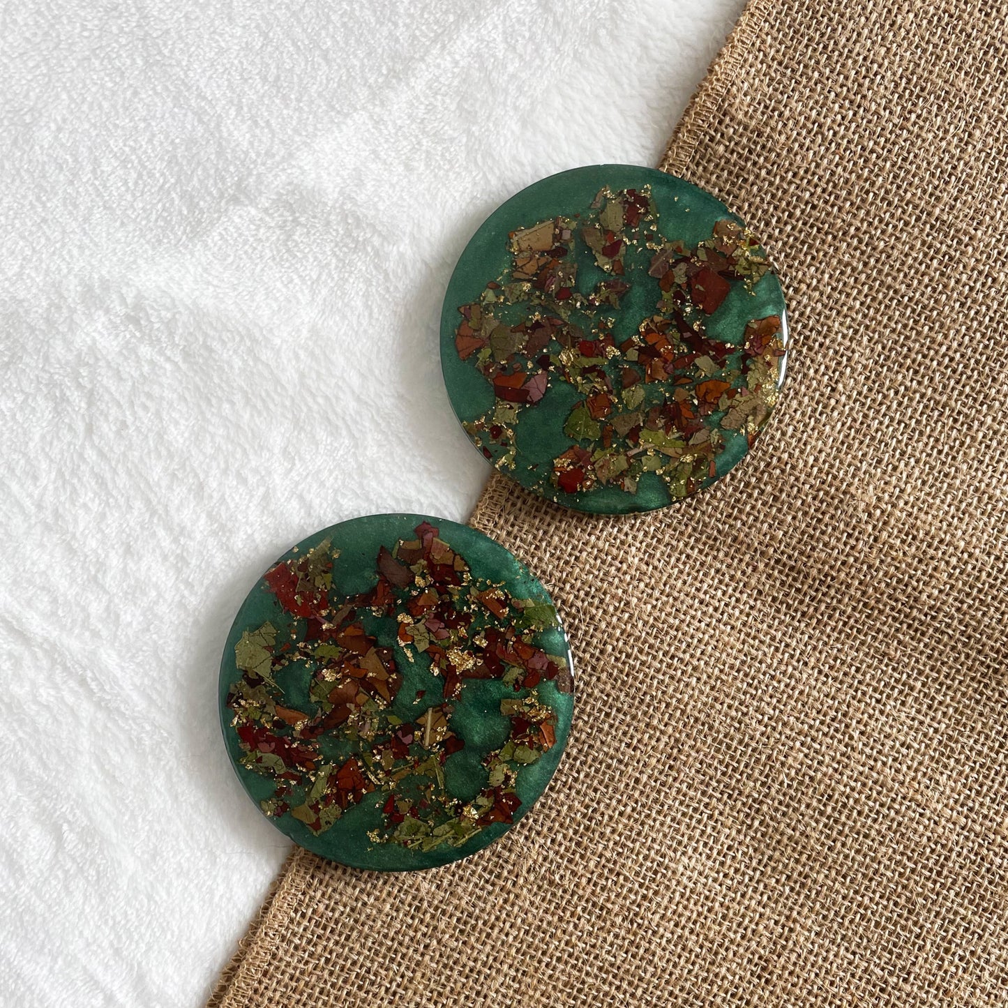 Handmade resin drink coaster with teal and rose petals, one-of-a-kind décor piece