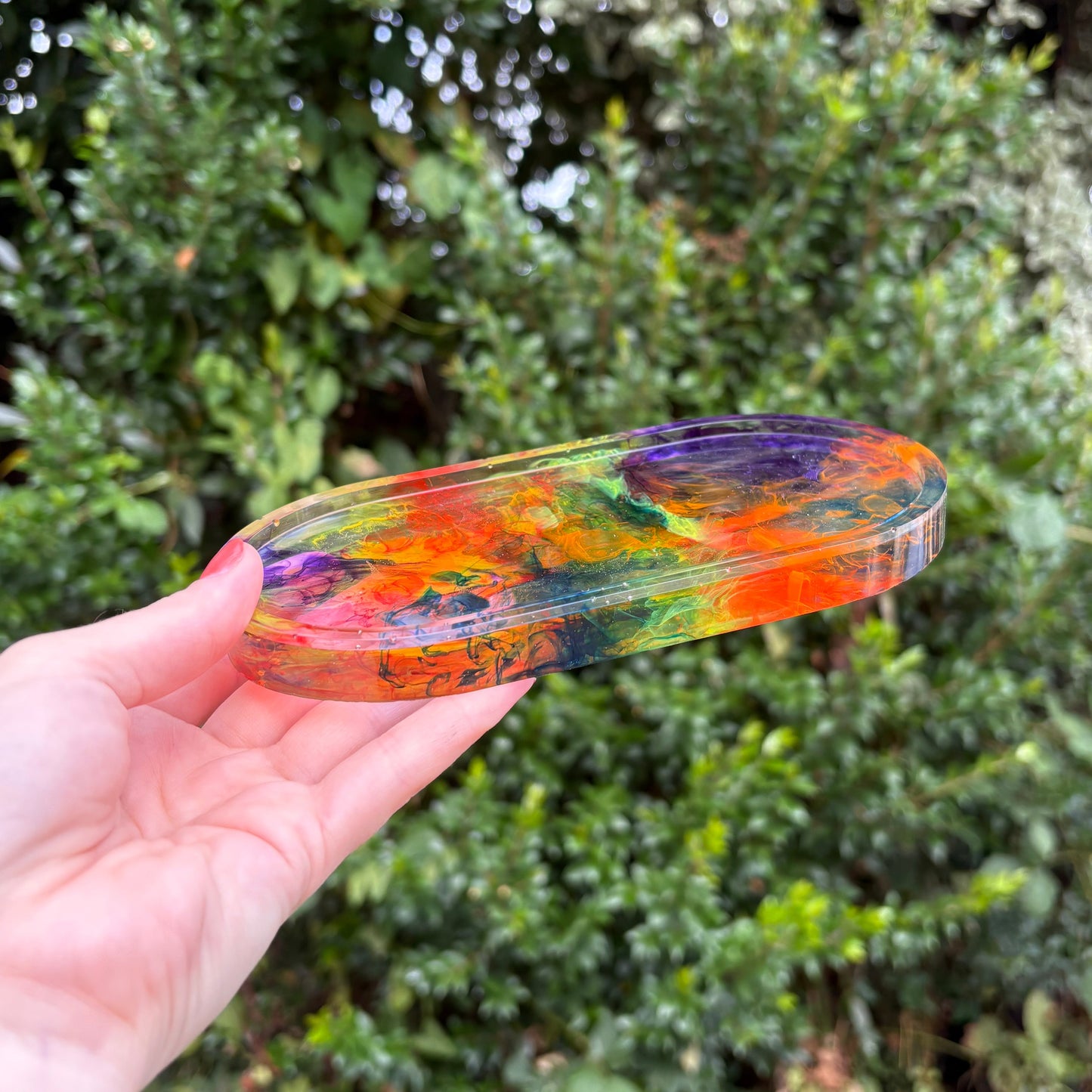 Clear resin soap dish with purple, orange, yellow, and blue marbling