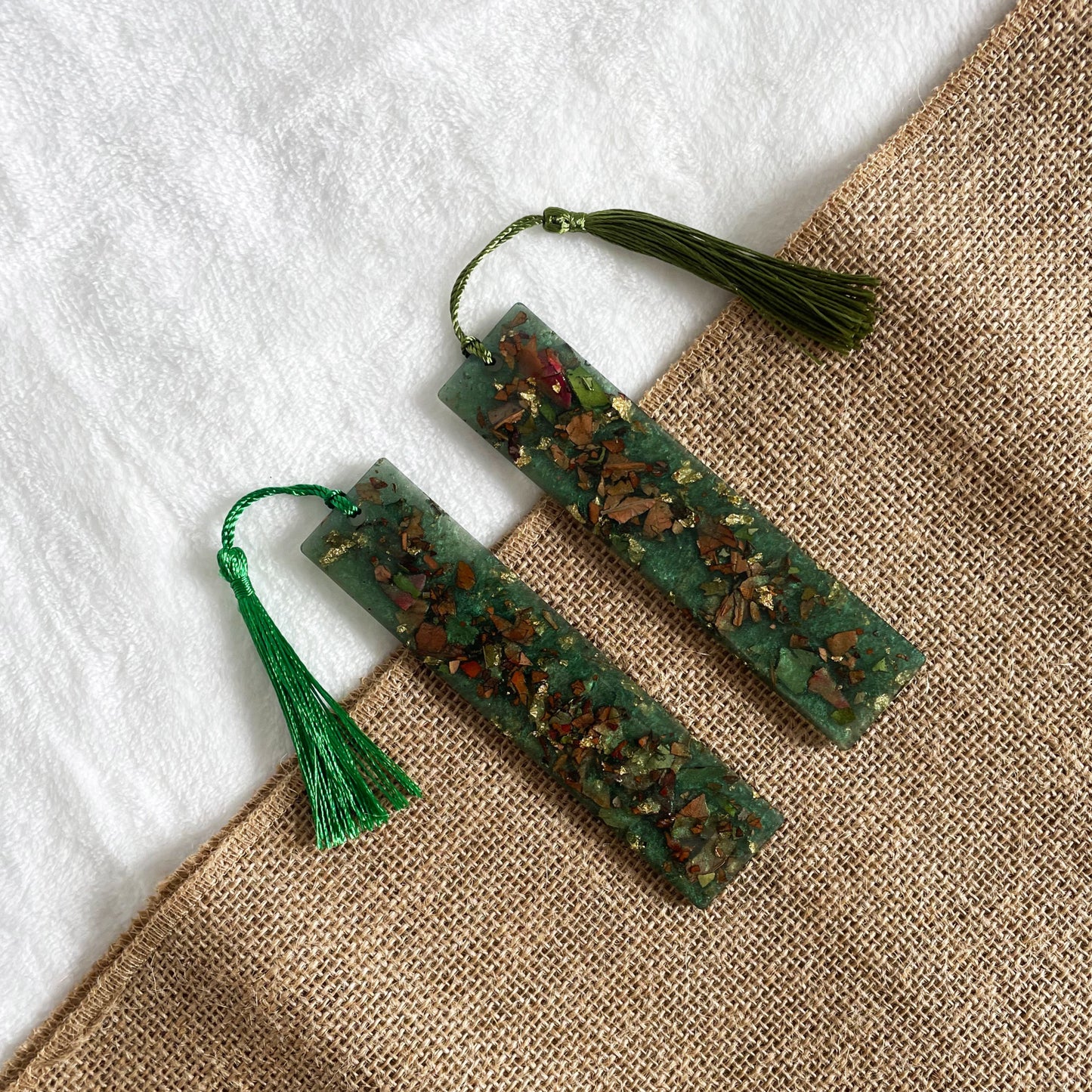 Handmade resin bookmark with teal tones and rose inclusions