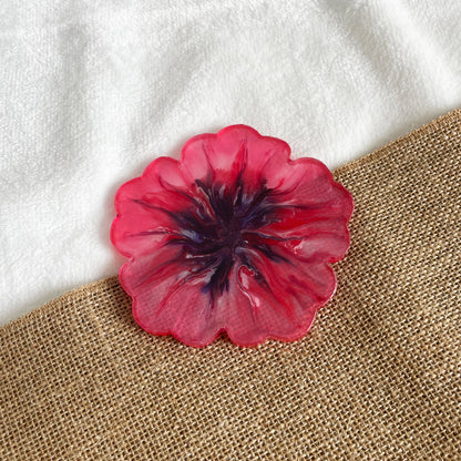 Artisan floral resin coaster with pink base and purple marbling, handmade home accent