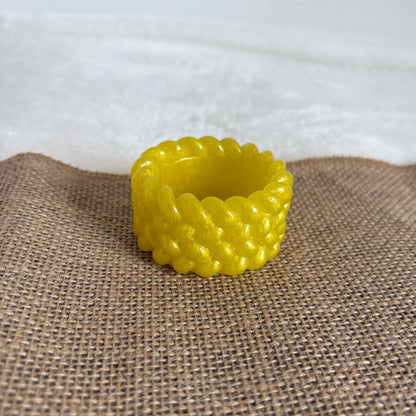 Yellow resin tealight holder with textured surface