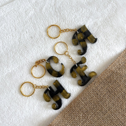 Handmade black resin keyring with gold marble swirl design