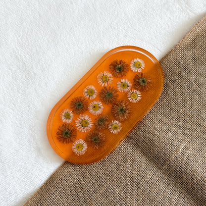 Orange resin jewellery tray with delicate floral accents