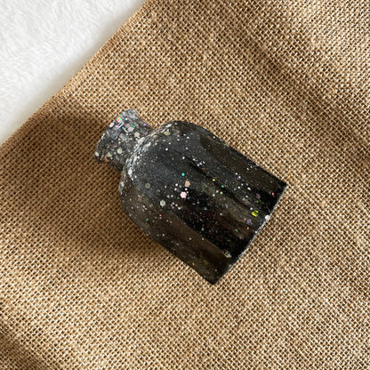 Rounded handmade resin vase with black and silver glitter