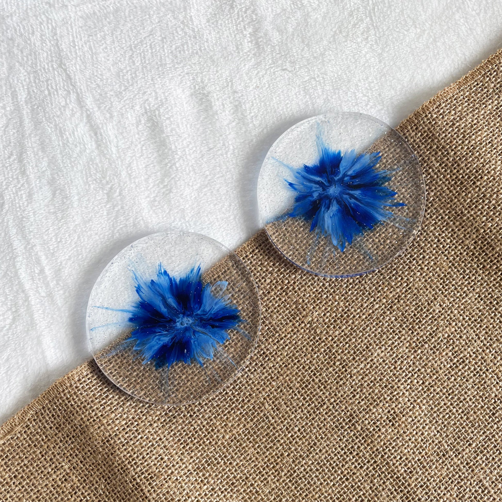 Unique round resin drink coaster with blue marbling, modern home décor accent